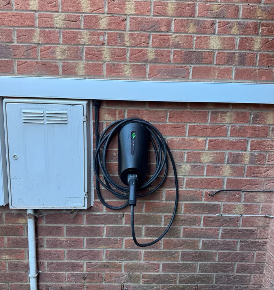 Carl Harvey's myenergi Zappi Glo EV charger mounted on an exterior brick wall